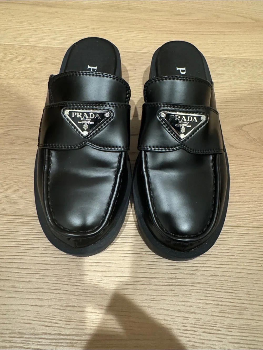 Prada women’s Black Leather Slide Loafers with Triangle Logo